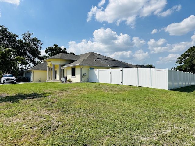 1601 SW California Blvd, Port Saint Lucie, FL 34953 - back of property featuring roof with shingles and stucco siding