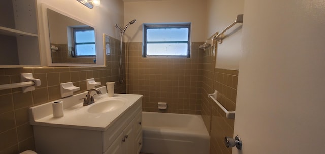 717 Hollywood Pl, West Palm Beach, FL 33405 - bathroom featuring tile walls, bathing tub / shower combination, vanity, and wainscoting