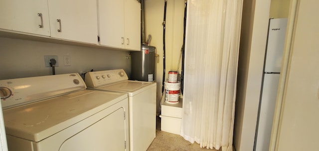 717 Hollywood Pl, West Palm Beach, FL 33405 - laundry area with washer and clothes dryer, water heater, and cabinet space