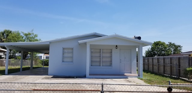 717 Hollywood Pl, West Palm Beach, FL 33405 - view of front facade with an attached carport