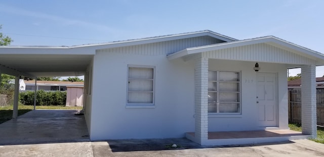 717 Hollywood Pl, West Palm Beach, FL 33405 - view of front of house featuring stucco siding and a carport