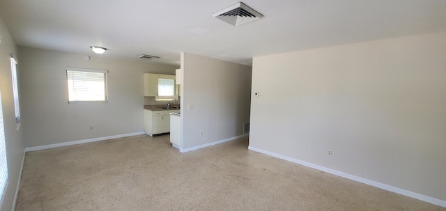 717 Hollywood Pl, West Palm Beach, FL 33405 - unfurnished living room with baseboards and a sink