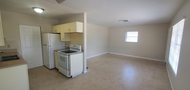 717 Hollywood Pl, West Palm Beach, FL 33405 - kitchen featuring white appliances, backsplash, a sink, and light countertops