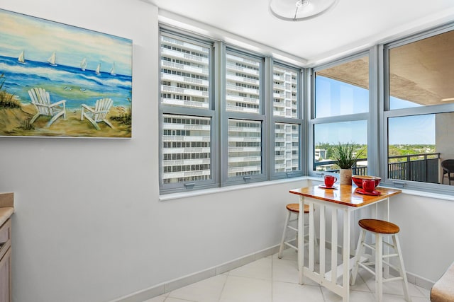 1180 S Ocean Blvd Unit 7B, Boca Raton, FL 33432 - tiled dining area featuring baseboards