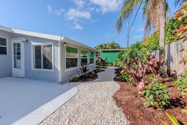 view of yard featuring fence and a patio area