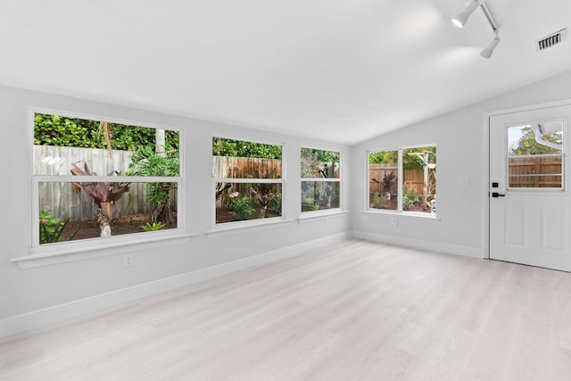 unfurnished sunroom featuring lofted ceiling