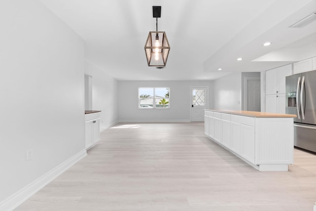 kitchen with stainless steel fridge with ice dispenser, recessed lighting, white cabinets, baseboards, and light wood-style floors