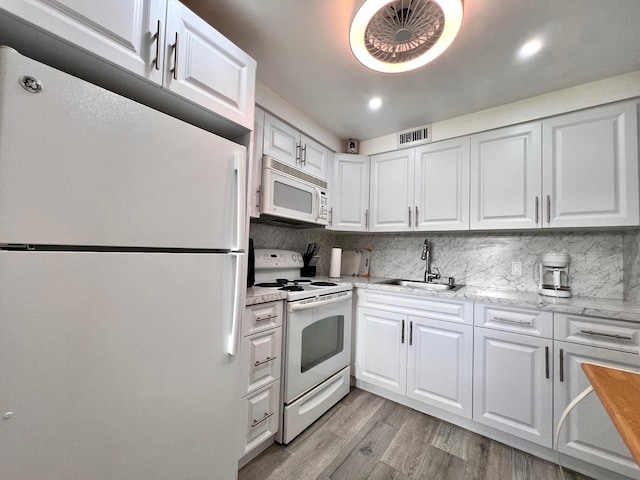 314 Chatham P, West Palm Beach, FL 33417 - kitchen featuring white appliances, a sink, white cabinetry, light wood-type flooring, and recessed lighting