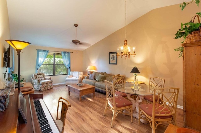 13045 Albright Ct Unit 12, Wellington, FL 33414 - living room featuring vaulted ceiling, light wood-type flooring, a chandelier, and baseboards