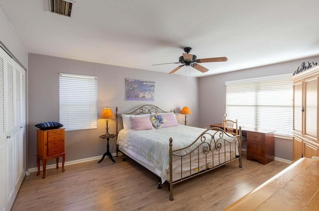 13045 Albright Ct Unit 12, Wellington, FL 33414 - bedroom with light wood-type flooring, baseboards, a closet, and ceiling fan