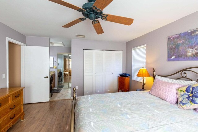 13045 Albright Ct Unit 12, Wellington, FL 33414 - bedroom with wood finished floors, a closet, ceiling fan, and connected bathroom