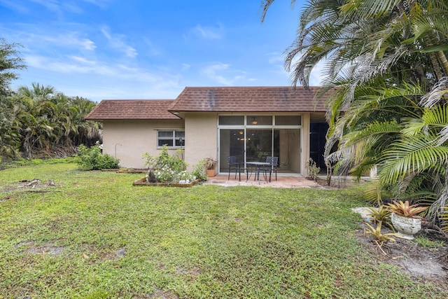 1920 Palmland Dr Unit C, Boynton Beach, FL 33436 - back of property featuring stucco siding, mansard roof, roof with shingles, a lawn, and a patio area
