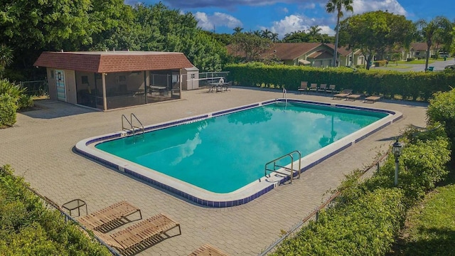 1920 Palmland Dr Unit C, Boynton Beach, FL 33436 - community pool with a patio and an outbuilding