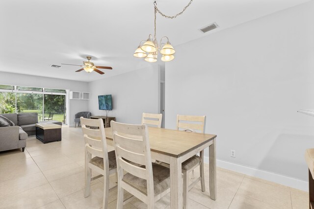 1920 Palmland Dr Unit C, Boynton Beach, FL 33436 - dining area featuring light tile patterned floors, ceiling fan, and a chandelier