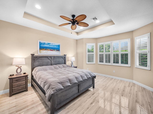 11416 SW Lake Park Dr, Port Saint Lucie, FL 34987 - bedroom featuring a raised ceiling, baseboards, light wood-style floors, recessed lighting, and a ceiling fan