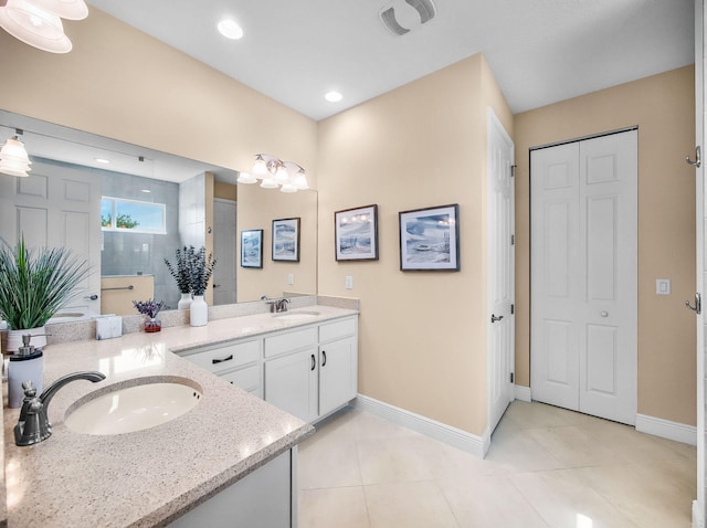 11416 SW Lake Park Dr, Port Saint Lucie, FL 34987 - full bath with baseboards, double vanity, walk in shower, tile patterned flooring, and recessed lighting