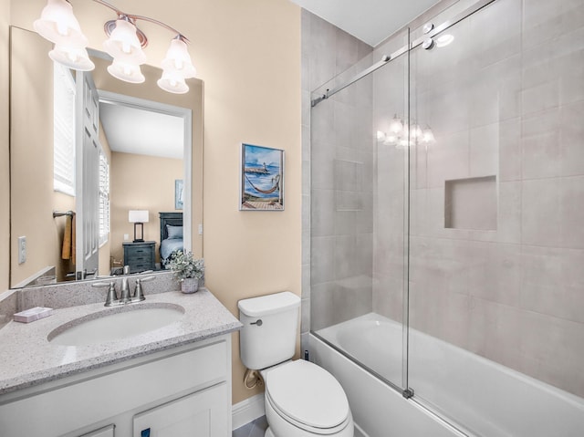 11416 SW Lake Park Dr, Port Saint Lucie, FL 34987 - bathroom featuring a chandelier, vanity, toilet, connected bathroom, and combined bath / shower with glass door