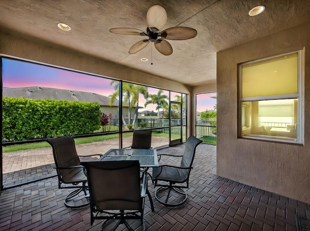 11416 SW Lake Park Dr, Port Saint Lucie, FL 34987 - sunroom / solarium with brick flooring, a ceiling fan, and outdoor dining area