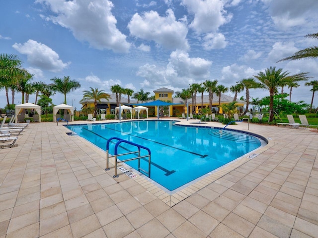 11416 SW Lake Park Dr, Port Saint Lucie, FL 34987 - community pool featuring a gazebo and a patio area