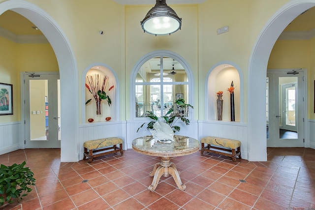 11416 SW Lake Park Dr, Port Saint Lucie, FL 34987 - lobby with a decorative wall, a high ceiling, and a wainscoted wall