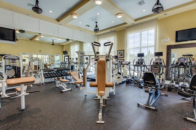 11416 SW Lake Park Dr, Port Saint Lucie, FL 34987 - exercise room with a towering ceiling and beam ceiling
