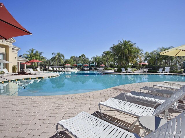11416 SW Lake Park Dr, Port Saint Lucie, FL 34987 - community pool with a patio area