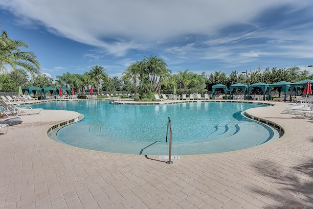 11416 SW Lake Park Dr, Port Saint Lucie, FL 34987 - community pool featuring a patio area