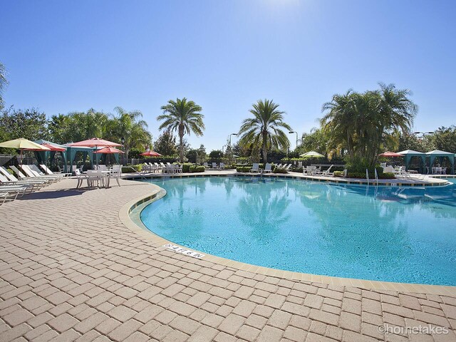 11416 SW Lake Park Dr, Port Saint Lucie, FL 34987 - community pool featuring a patio area