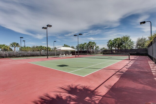 11416 SW Lake Park Dr, Port Saint Lucie, FL 34987 - view of tennis court featuring fence and community basketball court