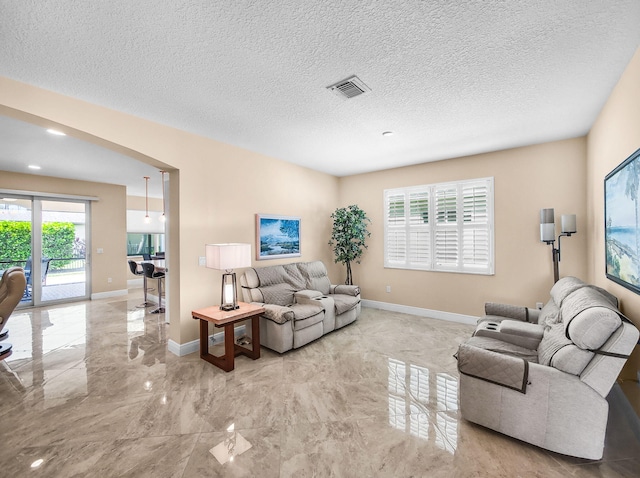 11416 SW Lake Park Dr, Port Saint Lucie, FL 34987 - living area with marble tiled flooring, plenty of natural light, baseboards, and a textured ceiling