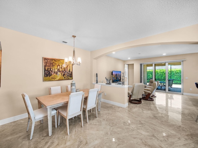 11416 SW Lake Park Dr, Port Saint Lucie, FL 34987 - dining space featuring marble tiled flooring, a chandelier, baseboards, a textured ceiling, and arched walkways