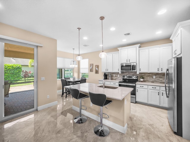 11416 SW Lake Park Dr, Port Saint Lucie, FL 34987 - kitchen featuring stainless steel appliances, a sink, light countertops, white cabinetry, and recessed lighting