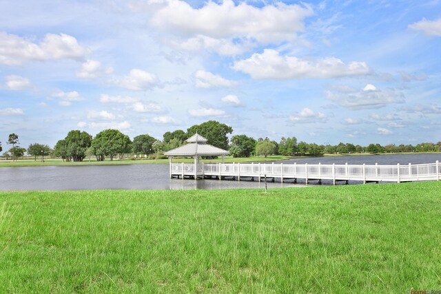 11416 SW Lake Park Dr, Port Saint Lucie, FL 34987 - dock with a gazebo, a lawn, and a water view