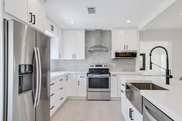 5830 SW 51st Ter, Miami, FL 33155 - kitchen with stainless steel appliances, wall chimney range hood, a sink, light countertops, and recessed lighting