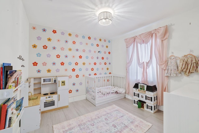 5830 SW 51st Ter, Miami, FL 33155 - bedroom with light wood-style floors, a crib, and baseboards