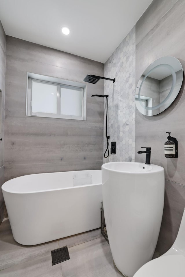 5830 SW 51st Ter, Miami, FL 33155 - bathroom with tile walls, a shower, and a freestanding bath