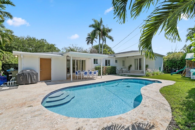 5830 SW 51st Ter, Miami, FL 33155 - swimming pool featuring a playground, a patio area, a lawn, french doors, and a grill