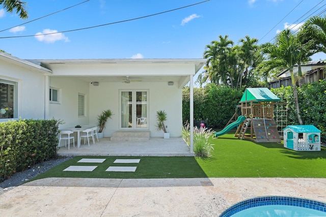 5830 SW 51st Ter, Miami, FL 33155 - back of property with a playground, a yard, a patio area, a ceiling fan, and stucco siding