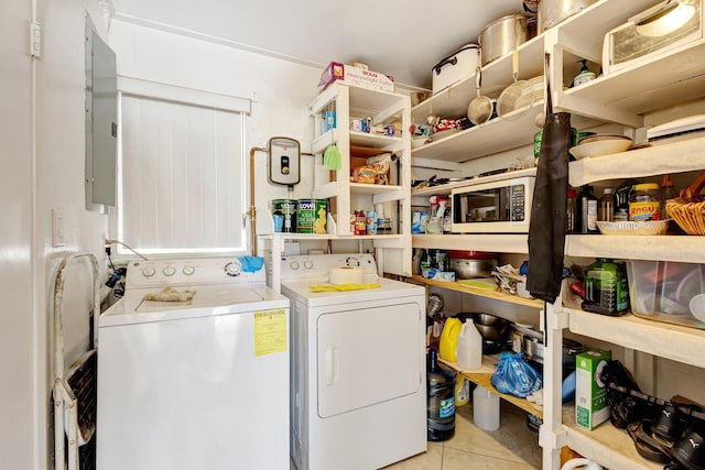 2425 S Florida Mango Rd, West Palm Beach, FL 33406 - clothes washing area featuring washing machine and clothes dryer, tile patterned floors, and electric panel
