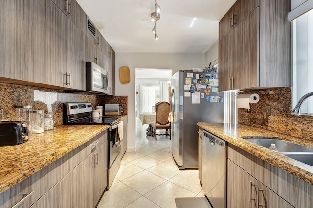 2425 S Florida Mango Rd, West Palm Beach, FL 33406 - kitchen with appliances with stainless steel finishes, a sink, tasteful backsplash, light tile patterned floors, and light stone counters