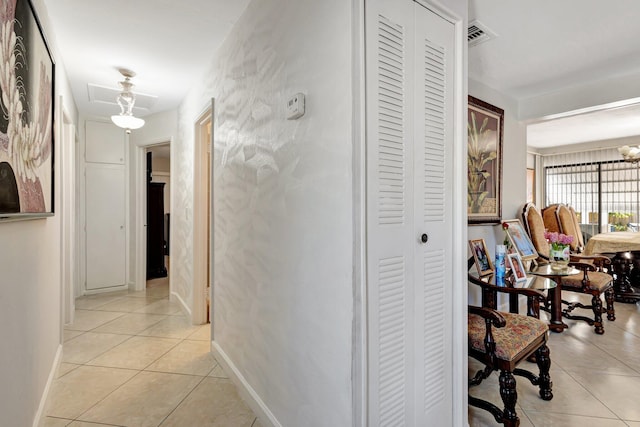 2425 S Florida Mango Rd, West Palm Beach, FL 33406 - hall featuring light tile patterned floors, baseboards, and a chandelier