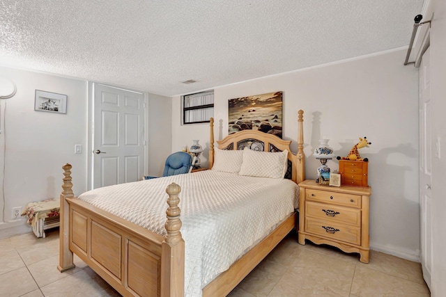2425 S Florida Mango Rd, West Palm Beach, FL 33406 - bedroom featuring a textured ceiling, light tile patterned flooring, and baseboards