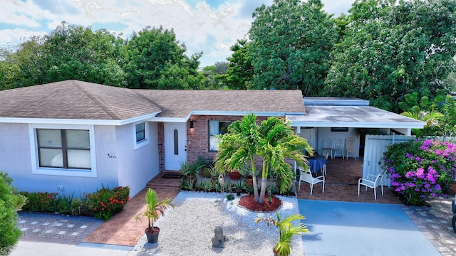 2425 S Florida Mango Rd, West Palm Beach, FL 33406 - view of front of property with a shingled roof, stucco siding, and brick siding
