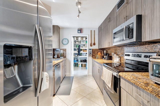 2425 S Florida Mango Rd, West Palm Beach, FL 33406 - kitchen with stainless steel appliances, light tile patterned flooring, backsplash, and modern cabinets