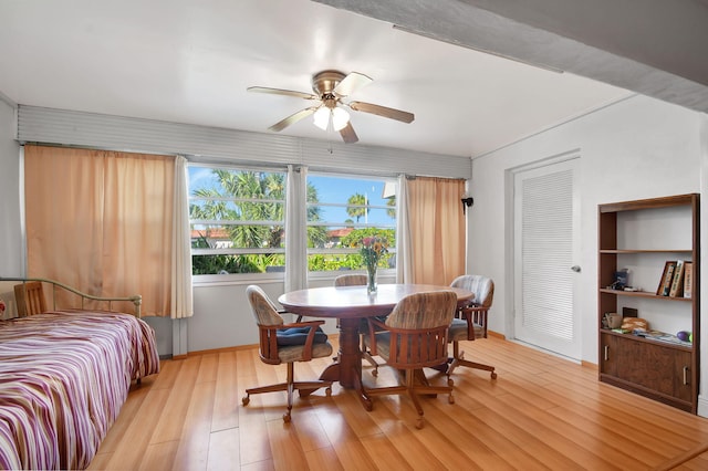 dining space with a ceiling fan, light wood-style floors, and baseboards