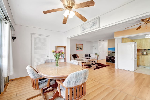 dining room with ceiling fan and light wood finished floors