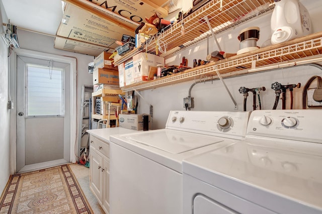 laundry area with washing machine and dryer and baseboards