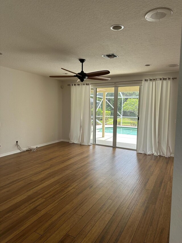 207 Pennock Trace Dr, Jupiter, FL 33458 - empty room with a textured ceiling, dark wood-type flooring, baseboards, and a ceiling fan