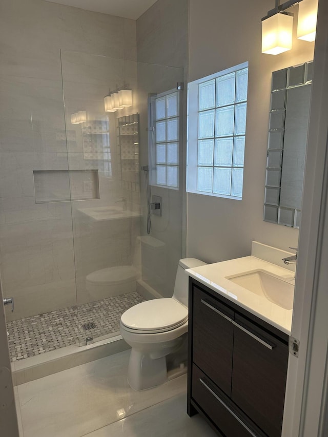 207 Pennock Trace Dr, Jupiter, FL 33458 - bathroom with toilet, a tile shower, tile patterned floors, and vanity
