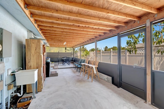 sunroom with healthy amount of natural light and a sink